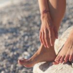 person foot on brown rock