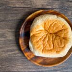 a round brown pastry on a wooden surface