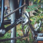 selective focus photo of bicycle derailleur and sprocket